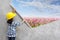 Little girl engineering with painting flowers grass on wall