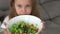 Little girl enjoy eating with vegetable salad at home. eating vegetables by child make them healthier