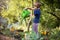 Little girl enjoy gardening in urban community garden