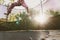 Little girl enjoying her vacation jumping on the trampoline doing acrobatic exercise outdoors