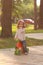 Little girl enjoying long waiting pop corn while riding a small bike