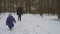 Little girl enjoying running on snowy forest trail