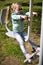 Little girl exercising on outdoor fitness machine