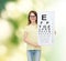 Little girl in eyeglasses with eye checking chart