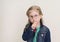 Little girl in eyeglasses putting finger up to lips and ask silence. Child  doing a Please Keep Quiet gesture towards the camera