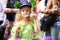 A little girl in fancy green dress blow soap bubbles