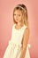 Little girl in fashionable dress, prom. Beauty Fashion model girl. Fashion look. Fashion model on pink background