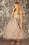 Little girl in fashionable dress, prom. Child girl in stylish glamour dress, elegance. Fashion model on silver