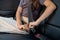 Little girl fastening safety belt while sitting in car