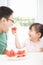 little girl with father eating fruits