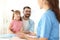 Little girl with father visiting children`s doctor