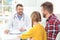 Little girl with father visiting children`s doctor