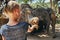 Little girl feeding a banana to an Asian elephant