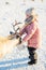 Little girl feeding reindeer