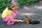 Little girl feeding squirrel with nuts