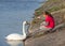 Little girl feeding swan