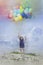 Little girl flies away with balloons; watercolor illustration