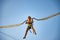 Little girl flies on elastic bands and jumps on a trampoline