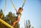 Little girl flies on elastic bands and jumps on a trampoline