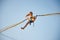 Little girl flies on elastic bands and jumps on a trampoline