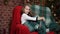 Little girl flirts sitting in a chair near a Christmas tree