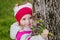 Little girl with floral bouquet in woodland