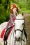 Little girl in floral wreath riding horse