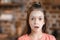 Little girl with flour on face looking at camera