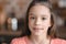 Little girl with flour on nose smiling at camera