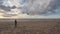 Little girl flying a kite on the beach