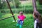 Little girl flying on swing in countryside. Childhood, Freedom,