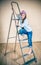 Little girl on a folding ladder