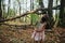 Little girl in the forest with ferns