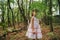 Little girl in the forest with ferns