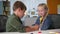 little girl with fractured limb play at room, kids with felt-tip pen are drawing on plaster cast on the hand while