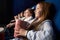 Little girl with friends sitting in cinema.