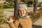 Little girl with funny kiss face and grey bonnet taking a selfie