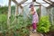 Little girl gardening in greenhouse