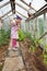 Little girl gardening in greenhouse