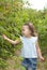 Little girl gathering raspberries