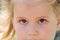Little girl gazes brown eyes