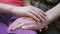 Little girl gently stroking hands of her elderly grandmother, love and care