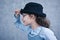 Little girl in glasses and black hat profile