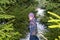 Little girl in glasses in winter among fir trees