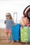 A little girl goes on a journey on a red car