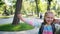 Little girl going to school through park