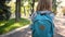 Little girl going to school through park