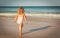 little girl going to swim on beach