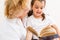 Little girl with grandma reading interestng book