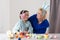 Little girl with grandmother dyeing Easter eggs